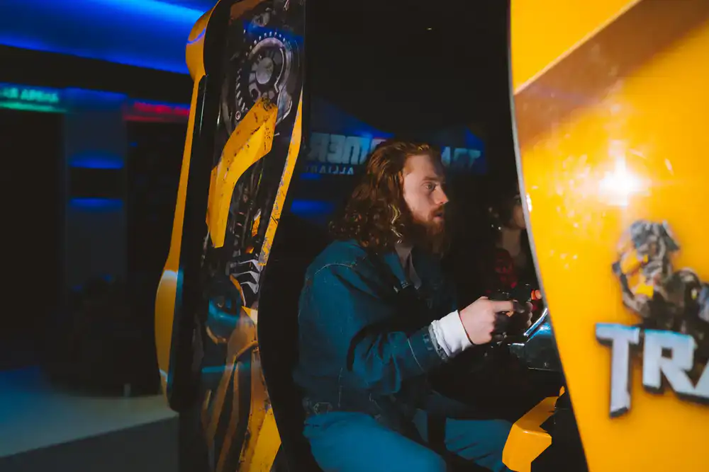 Focused player at a rhythm game cabinet
