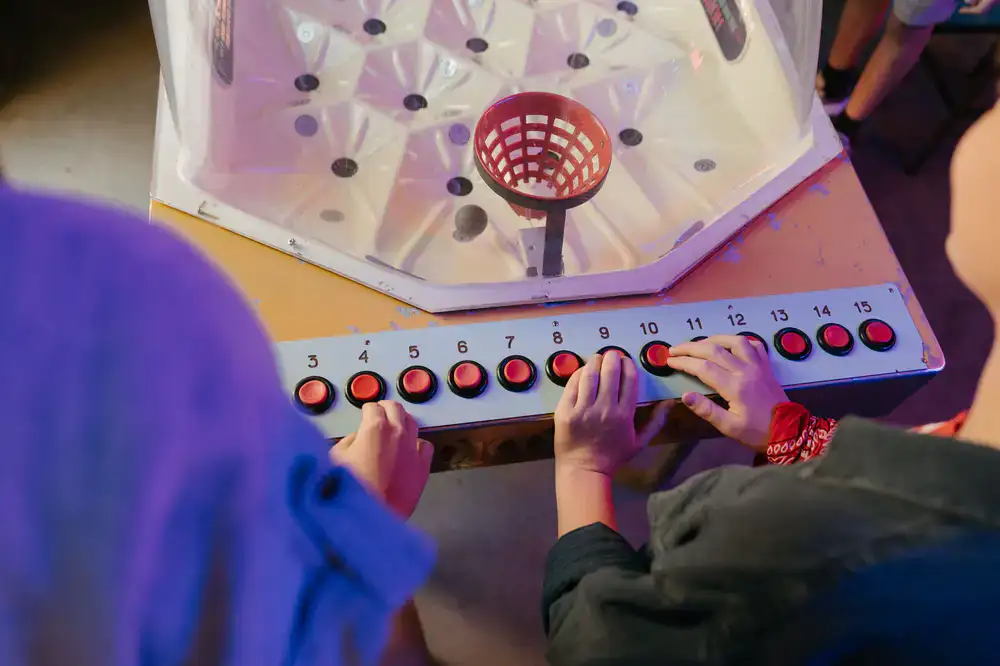 Two players competing on a fast-paced dance pad machine