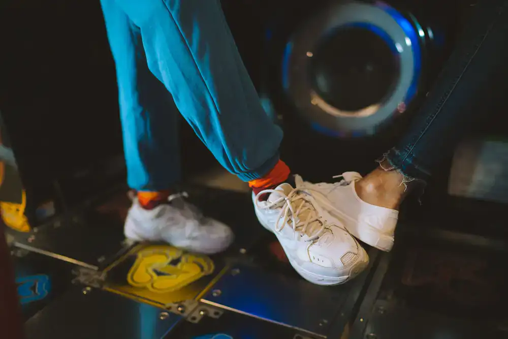 Player hitting notes on a glowing dance pad machine